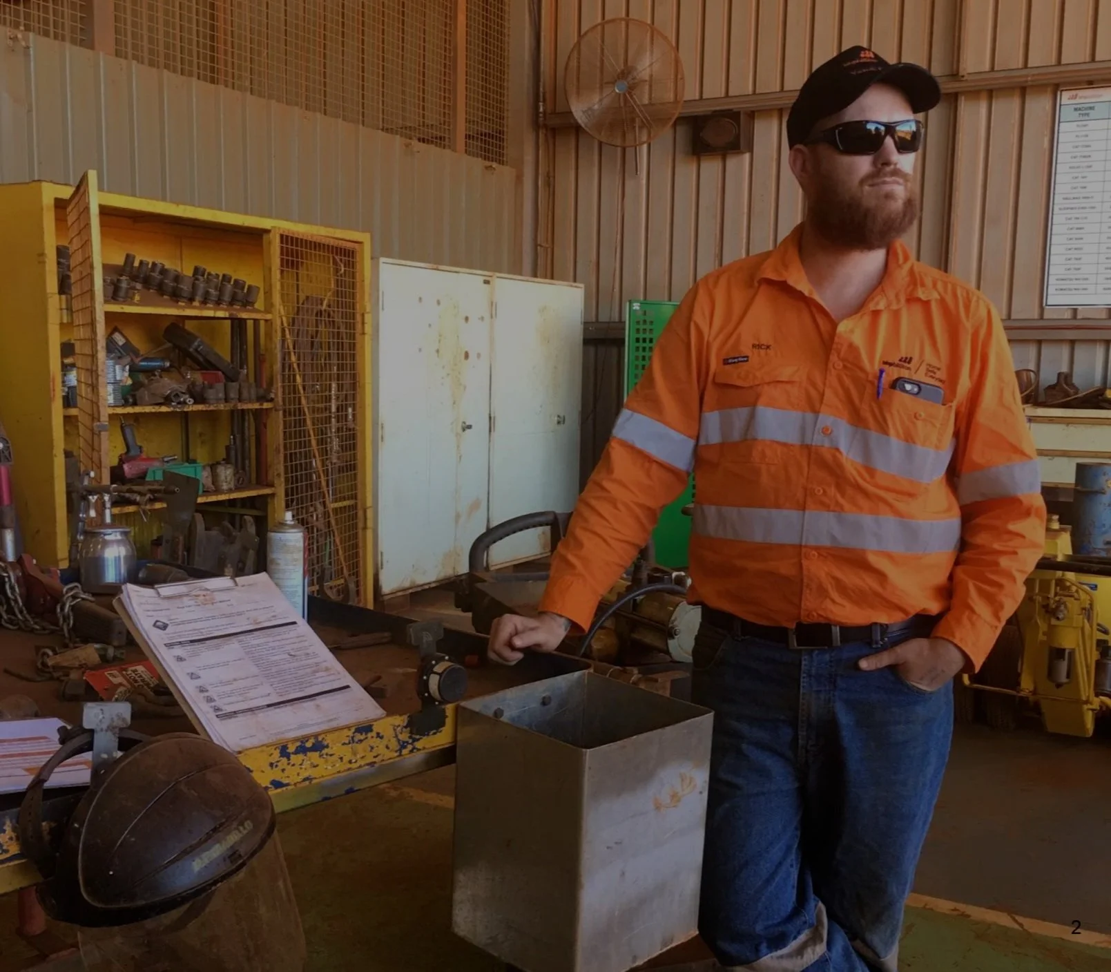 A worker in hi-vis with the paper instruction binder